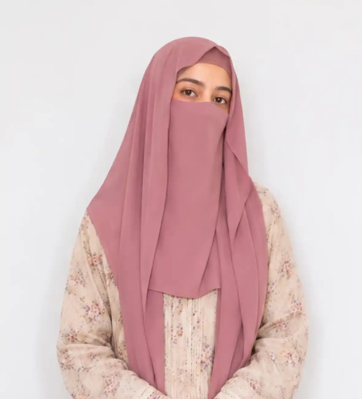 Woman wearing rose mauve chiffon niqab hijab with floral abaya