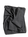 Folded black fabric on a white background