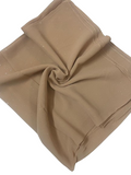 Folded beige fabric on a white background