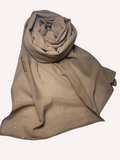 Beige hijab with subtle patterns on a white background