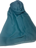 Teal scarf with small white specks on a white background