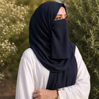 Woman wearing classic black georgette hijab with matching niqab outdoors