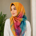 Woman wearing orange teal watercolor slub lawn hijab styled look
